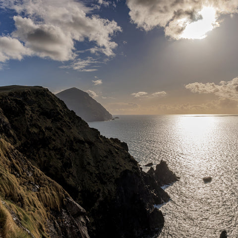 Clare Island looking towards the sun beaming down on the Atlantic Ocean.