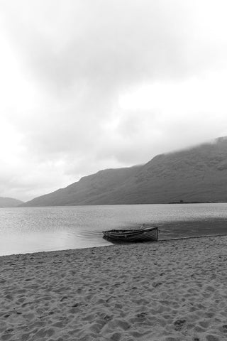 Calm. A single boat on the sand in the rain at Lough Nafooey in County Galway. Looking towards the Mayo border.  Lough Nafooey is a rectangular shaped glacial lake on the border of County Mayo and County Galway.