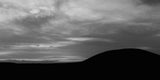  A black and white silhouette of the Mound of Hostages.