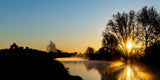 A beautiful sunrise over the River Boyne at the ruins at Newtown, Trim. The sun casting beautiful shadows of the trees over the river.