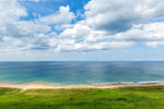 A breathtaking view of White Park Bay in Antrim with a cloudy sky.